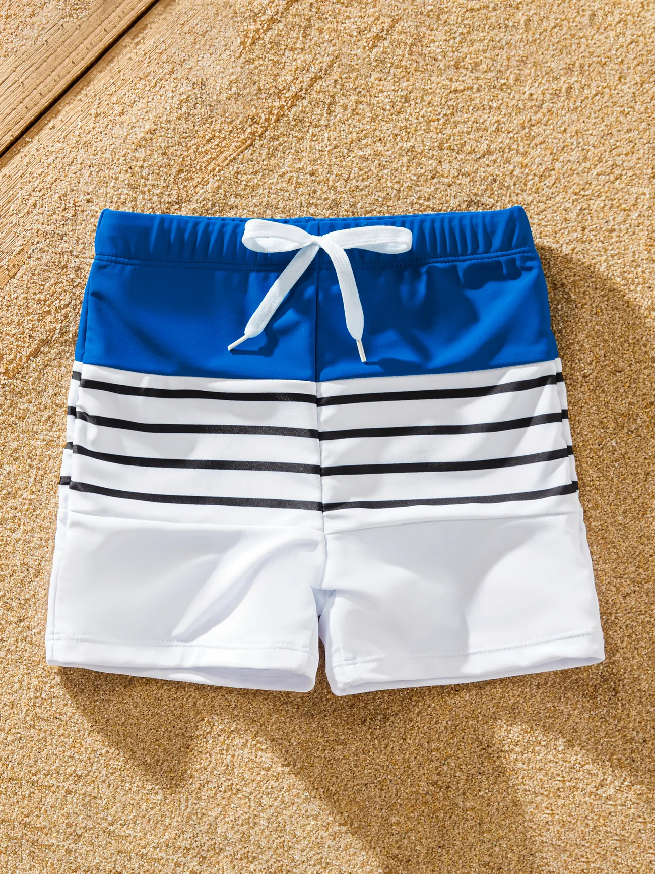 Matching Family Swimsuit Colorblock Drawstring Swim Trunks or Striped Blue Spliced Tankini with Cross-Front, Tie-Back, and Thin Straps
Matching Family Swimsuit Colorblock Drawstring Swim Trunks or Striped Blue Spliced Tankini with Cross-Front, Tie-Back, and Thin Straps