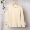Kid Girl 3D Bowknot Design Mock Neck Solid Color Cotton Long-sleeve Tee BlanchedAlmond image 1