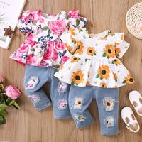2pcs Baby Girl 95% Cotton Ripped Denim Jeans and Allover Sunflowers Print Ruffle Short-sleeve Top Set