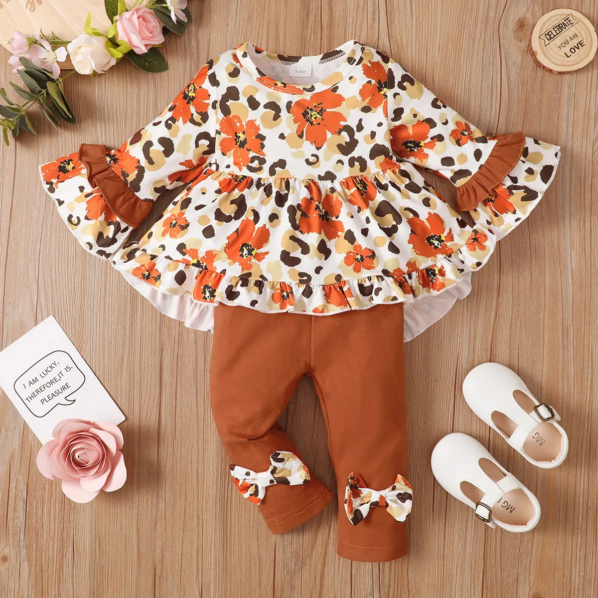 

2pcs Baby Girl 95% Cotton Bow Front Leggings Pants and Allover Floral Print Bell-sleeve Irregular Ruffle Hem Top Set