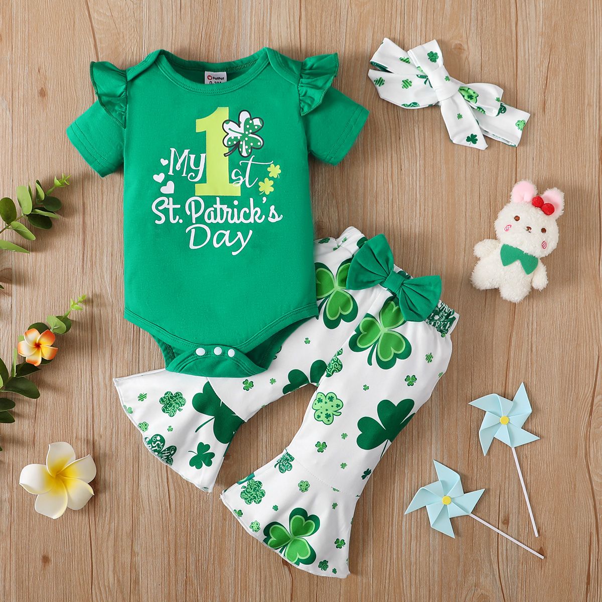 

St. Patrick's Day 3pcs Baby Girl 95% Cotton Ruffle Short-sleeve Letter Graphic Romper and Allover Leaf Print Flared Pants & Headband Set