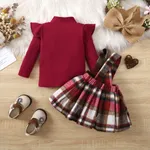 2pcs Baby Girl 95% Cotton Ribbed Solid Ruffle Long-sleeve Top and Plaid Bow Decor Strappy Skirt Set  image 3