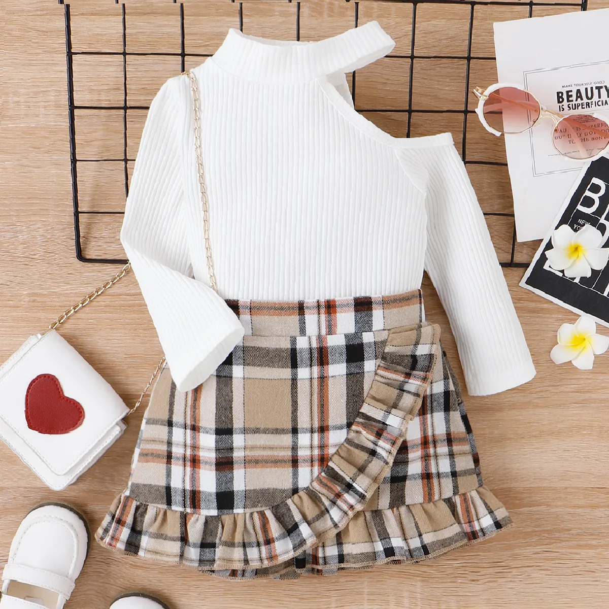 

2pcs Toddler Girl Sweet Cold Shoulder Ribbed Tee and Ruffled Wrap Plaid Skirt Set