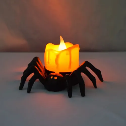 Una pieza de decoración de velas de calabaza de Halloween con luces LED y diseño de araña