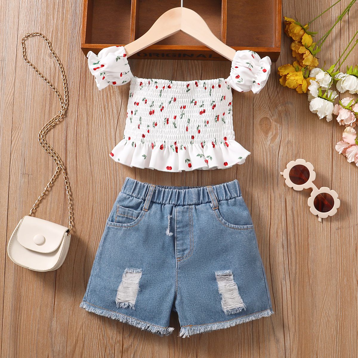 

2pcs Toddler Girl Trendy 100% Cotton Ripped Denim Shorts and Smocked Off Shoulder Tee Set