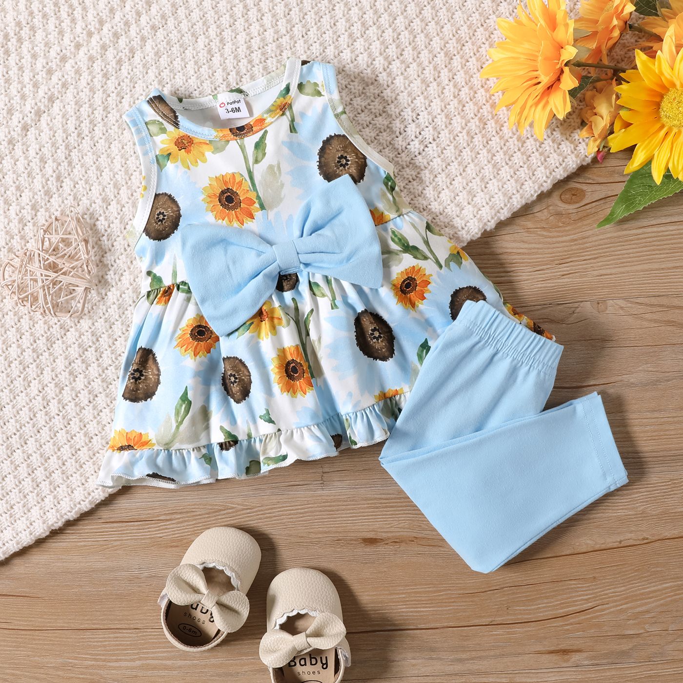 

2pcs Baby Girl Bow Decor Allover Sunflower Print Ruffle Sleeveless Top and 95% Cotton Solid Pants Set
