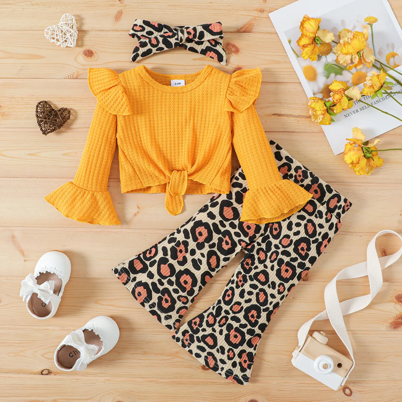

3pcs Baby Girl 95% Cotton Leopard Flared Pants and Solid Waffle Ruffle Trim Bell Sleeve Knot Front Crop Top with Headband Set