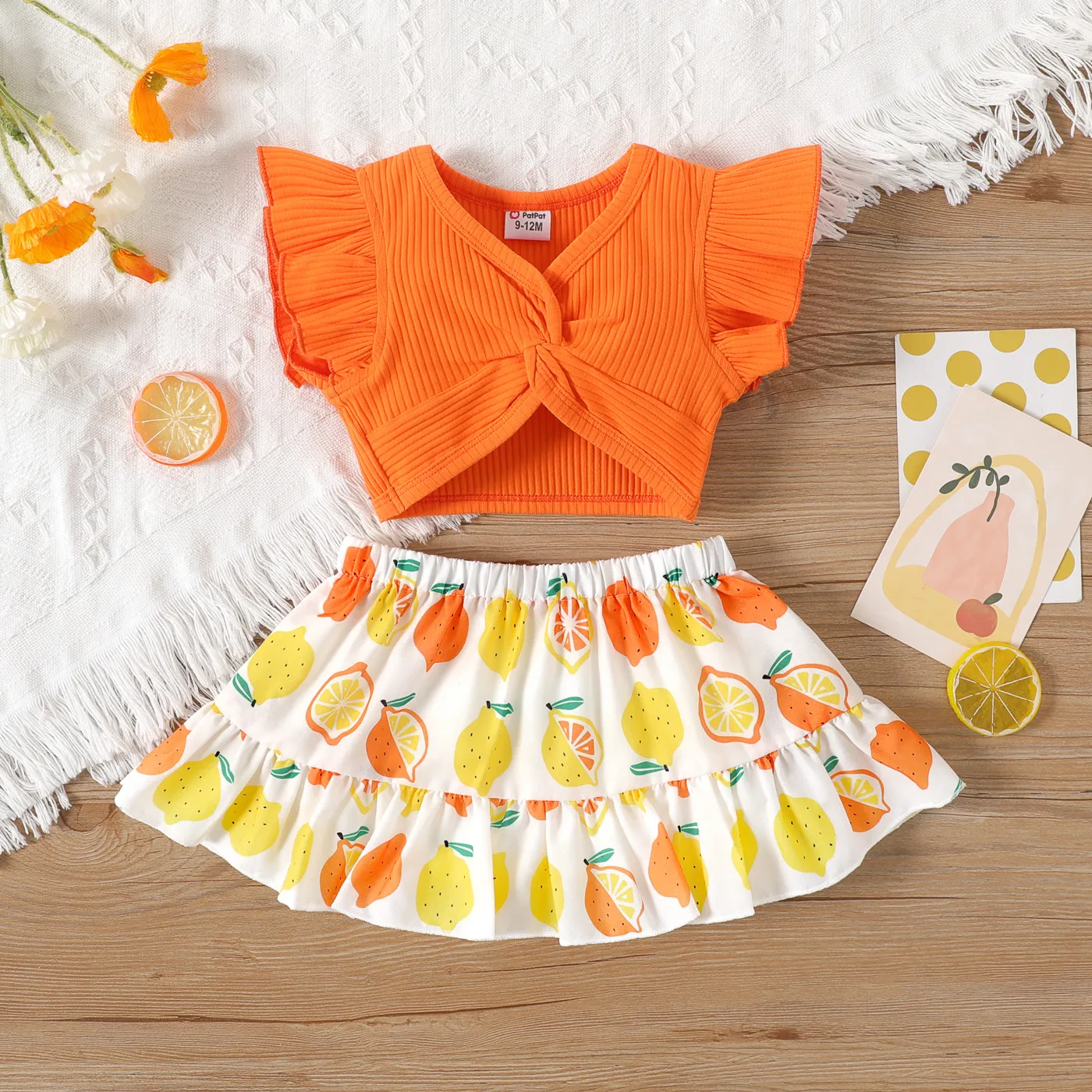 2pcs Baby Girl Solid Cotton Ribbed Ruffle-sleeve Twist Knot Crop Top and Allover Fruit Print Skirt S