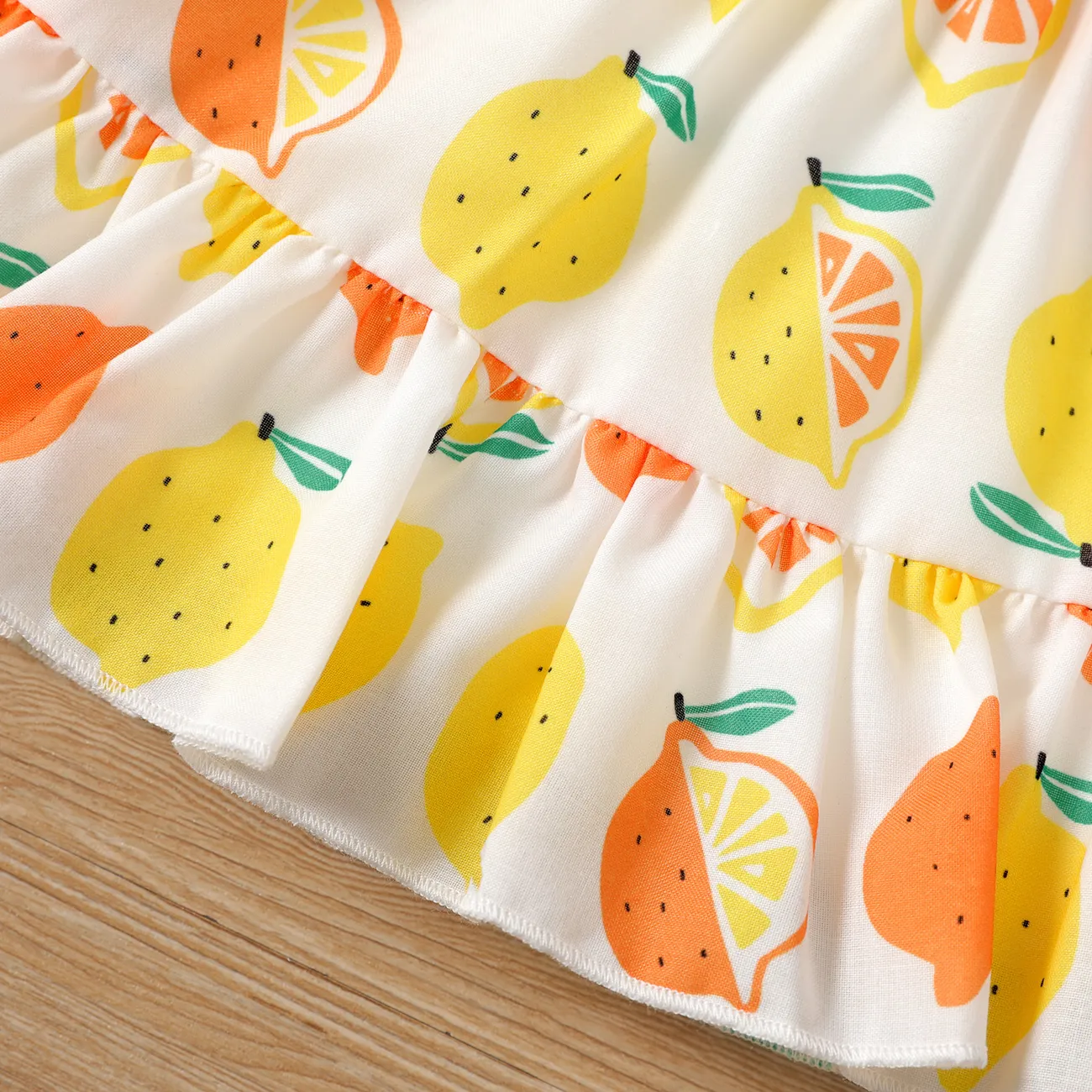 2pcs Baby Girl Solid Cotton Ribbed Ruffle-sleeve Twist Knot Crop Top and Allover Fruit Print Skirt Set Orange big image 1