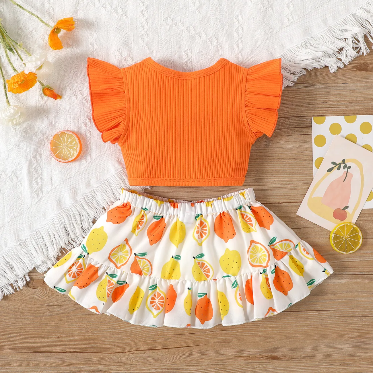 2pcs Baby Girl Solid Cotton Ribbed Ruffle-sleeve Twist Knot Crop Top and Allover Fruit Print Skirt Set Orange big image 1