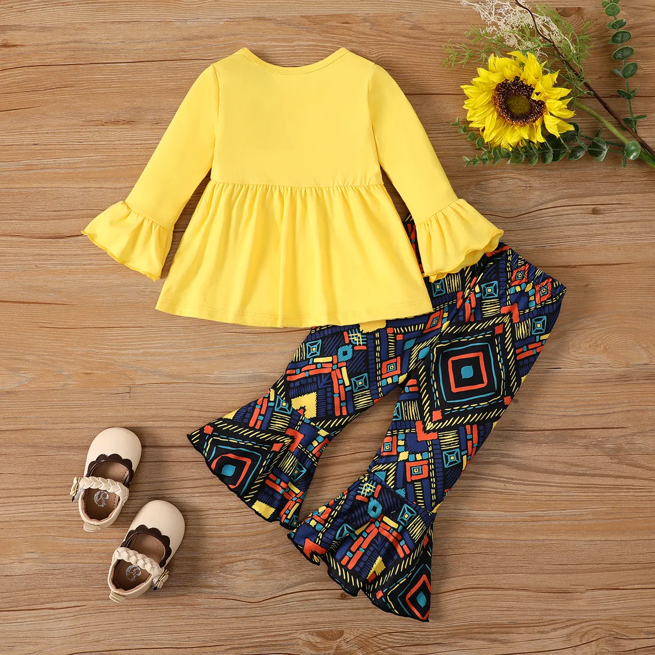2pcs Baby Girl Bow Decor Peplum Top and Allover Pattern Flared Pants Set Yellow big image 1